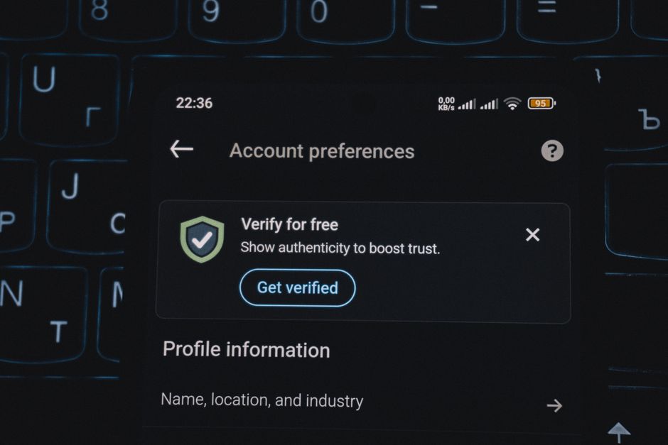 Close-up of a smartphone screen displaying account verification alert.